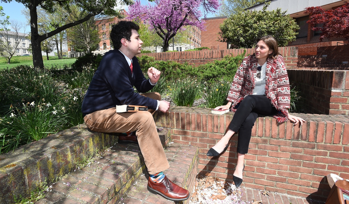 Two students talking outside Aquinas Hall